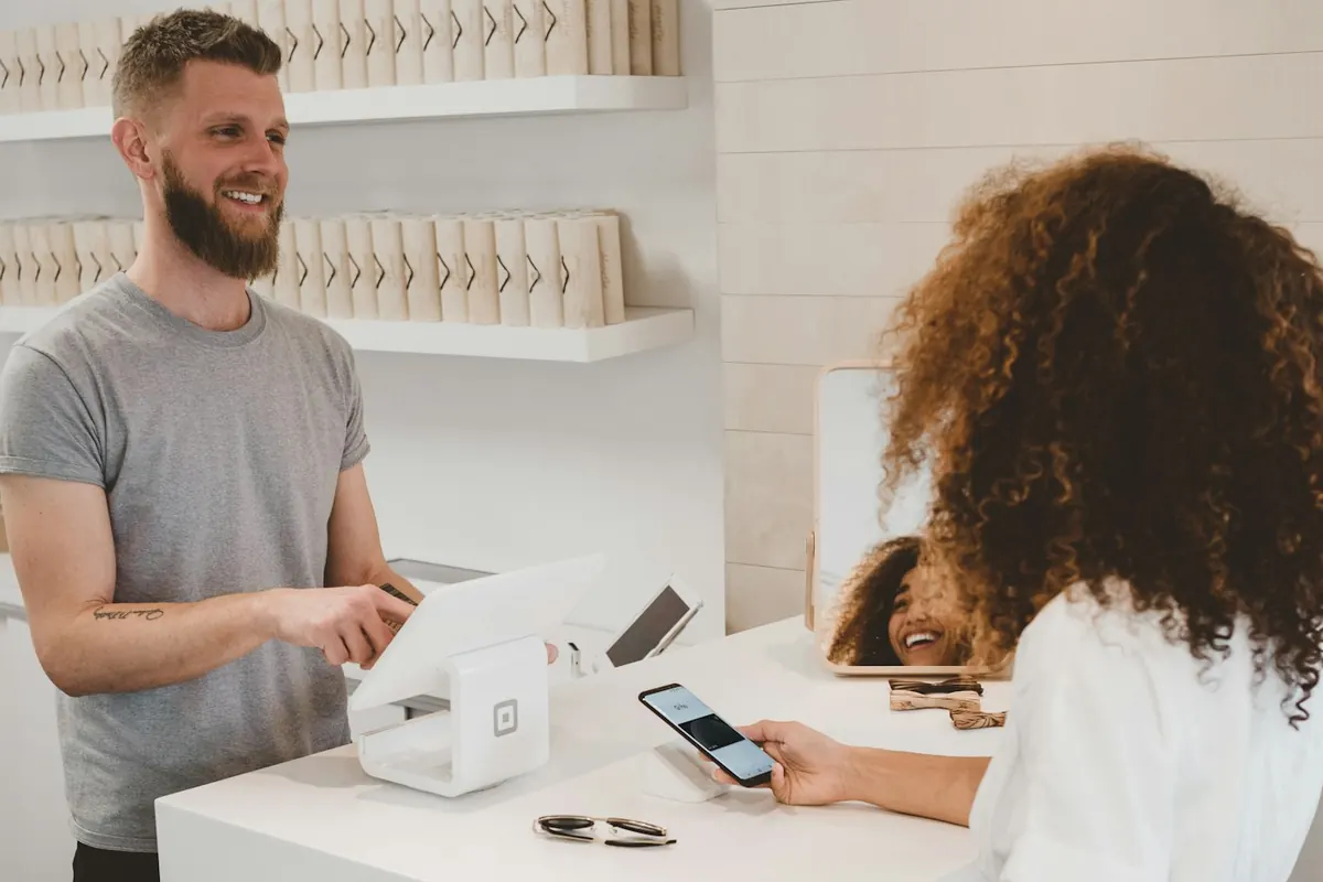 A shop owner taking a card payment from a customer